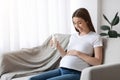 Healthy Calcium Drink. Pregnant Lady Holding Glass Of Milk, Relaxing At Home