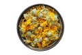 Healthy calendula flowers. Bowl of dry marigold petals, isolated on white. Royalty Free Stock Photo