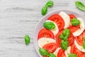 Healthy caprese salad with ripe tomatoes and mozzarella cheese with fresh basil leaves. Italian food. top view Royalty Free Stock Photo