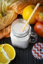 Healthy carrot, persimmon and orange smoothie in a jar with tube wooden background. Royalty Free Stock Photo