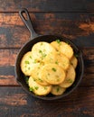 Healthy Cauliflower hash browns in cast iron frying pan on rustic wooden table