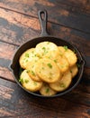 Healthy Cauliflower hash browns in cast iron frying pan on rustic wooden table