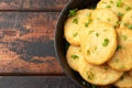 Healthy Cauliflower hash browns in cast iron frying pan on rustic wooden table