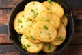 Healthy Cauliflower hash browns in cast iron frying pan on rustic wooden table