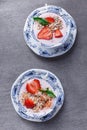 Healthy cereal with strawberries and yogurt decorate with mint in a ceramic bowls on wooden table. Granola, muesli Royalty Free Stock Photo