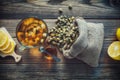 Chamomile tea cup, hessian bag of dry daisy flowers, honey jar and lemon slices. Royalty Free Stock Photo