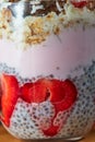 Chia seed pudding layered with strawberries, yogurt and cookie crumbs, close up Royalty Free Stock Photo