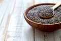 Healthy Chia seeds in a wooden spoon in a bowl on the table close-up. Text space. Royalty Free Stock Photo