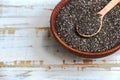 Healthy Chia seeds in a wooden spoon in a bowl on the table close-up. Text space. Royalty Free Stock Photo