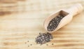 Healthy chia seeds in wooden spoon on wood table close-up Royalty Free Stock Photo