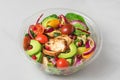 Healthy chicken salad with avocado, tomatoes and pomegranate in plastic package for take away or food delivery Royalty Free Stock Photo