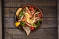 Healthy chicken salad with red cabagge and tomato on rustic wooden kitchen table Royalty Free Stock Photo