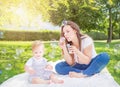 Healthy child (kid) having fun with mother and soap bubbles in a sunny summer day at the park. Royalty Free Stock Photo