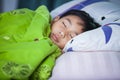 Healthy child. Little asian boy sleeping peacefully on bed.