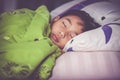 Healthy child. Little asian boy sleeping peacefully on bed. Vintage tone effect.