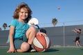 Healthy children lifestyle. Kids little boy playing basketball. Child sport activity. Smiling boy plays ball.