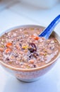 Healthy Chinese Grain Porridge in a Bowl with Jujube & Goji Berry on Top