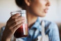 The healthy choice. A cropped shot of a young woman holding a glass of freshly squeezed juice.