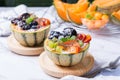 Fruit salad with yogurt in carved melon cantaloupe bowl Royalty Free Stock Photo