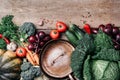 Healthy, clean food cooking and eating concept. Copper pan, colorful autumn vegetables on wooden background. Top view Royalty Free Stock Photo