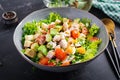 Healthy cobb salad with chicken, avocado, bacon, tomato, cheese and eggs