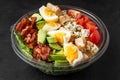 Healthy cobb salad in plastic package for take away or food delivery on black background. close up. low carb Royalty Free Stock Photo