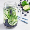 Healthy cold infused water with fresh blueberry, lime and rosemary, square format Royalty Free Stock Photo