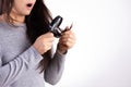 Healthy concept. Woman looking through a magnifying glass ends of her damaged long loss hair Royalty Free Stock Photo