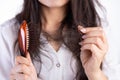 Healthy concept. Woman show her brush with damaged long loss hair and looking at her hair Royalty Free Stock Photo