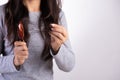 Healthy concept. Woman show her brush with damaged long loss hair and looking at her hair Royalty Free Stock Photo