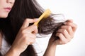 Healthy concept. Woman show her brush with damaged long loss hair and looking at her hair Royalty Free Stock Photo