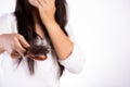 Healthy concept. Woman show her brush with damaged long loss hair and looking at her hair Royalty Free Stock Photo