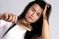 Healthy concept. Woman show her brush with damaged long loss hair and looking at her hair Royalty Free Stock Photo