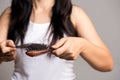 Healthy concept. Woman show her brush with long loss hair and looking at her hair Royalty Free Stock Photo