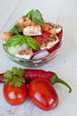 Healthy cooking of salad with fresh delicious ingredients making on cutting board. Royalty Free Stock Photo