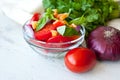 Healthy cooking of salad with fresh delicious ingredients making on cutting board. Royalty Free Stock Photo