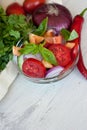 Healthy cooking of salad with fresh delicious ingredients making on cutting board.