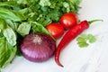 Healthy cooking of salad with fresh delicious ingredients making on cutting board. Royalty Free Stock Photo