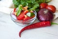 Healthy cooking of salad with fresh delicious ingredients making on cutting board. Royalty Free Stock Photo