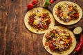 Healthy corn tortillas with grilled beef, fresh hot peppers, cheese, tomatoes