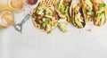 Healthy corn tortillas with grilled chicken, avocado, lime, beer