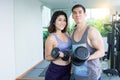 A couple is lifting dumbbells in gym Royalty Free Stock Photo