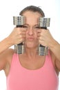 Healthy Crazy Young Woman Holding Dumb Bell Weights and Pulling Silly Facial Expression Royalty Free Stock Photo