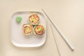 Healthy cucumber, salmon and avocado sushi roll with chopsticks. Vegetarian food Royalty Free Stock Photo