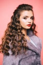 Healthy curls that look bouncy. Hair styling in beauty salon. Teenage girl with stylish wavy hairstyle. Pretty girl with