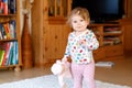 Portrait of little cute baby girl learning walking and standing. Adorable toddler girl at home Royalty Free Stock Photo