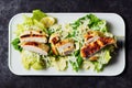 Healthy delicious chicken caesar salad with tender chicken and cheese