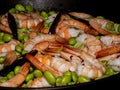 Healthy and delicious diet meal with shrimps, edamame beans and chili, served in a cast iron pot