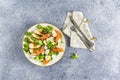 Healthy delicious plate of salad with chicken, lettuce, tomatoes, eggs, lemon juice and sesame on light gray table surface Royalty Free Stock Photo