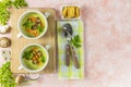 Healthy delicious potato cauliflower soup puree with carrot chips and croutons on a pink background, top view Royalty Free Stock Photo